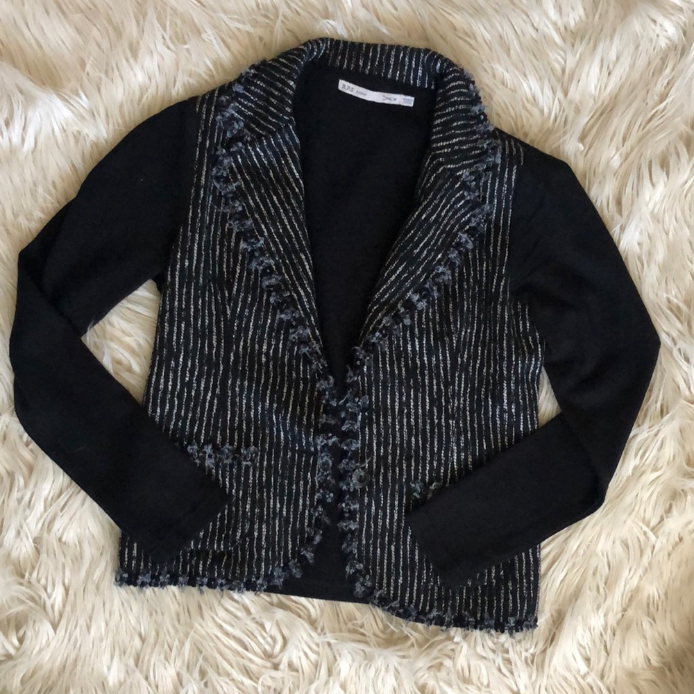 Tweed blazer with knit sleeves.